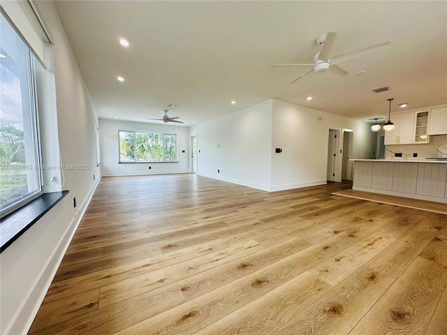 10361 NE 4th Ave, Miami Shores, FL 33138 - unfurnished living room with a ceiling fan, light wood-type flooring, recessed lighting, and baseboards