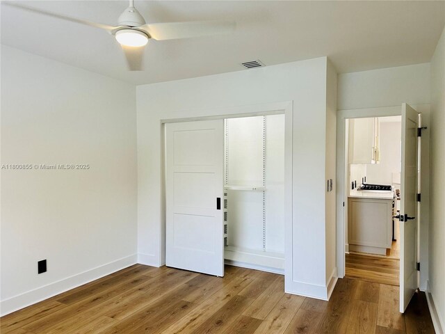 10361 NE 4th Ave, Miami Shores, FL 33138 - unfurnished bedroom with wood finished floors, baseboards, a closet, and ceiling fan
