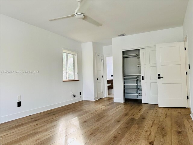 10361 NE 4th Ave, Miami Shores, FL 33138 - unfurnished bedroom with wood finished floors, baseboards, a ceiling fan, and a closet