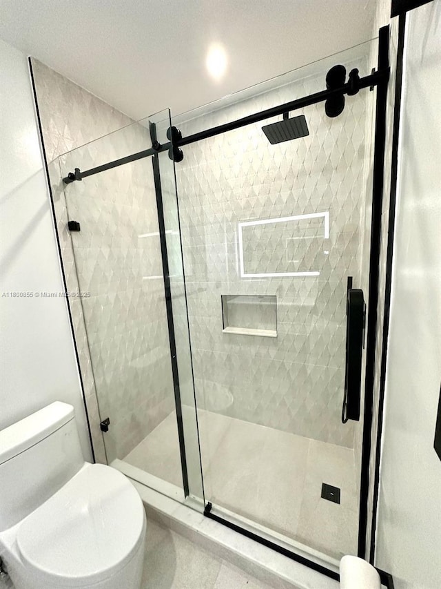 10361 NE 4th Ave, Miami Shores, FL 33138 - bathroom with toilet, a shower stall, and tile patterned floors