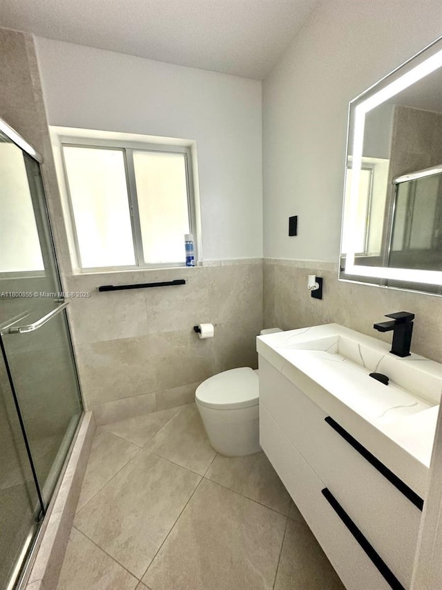 10361 NE 4th Ave, Miami Shores, FL 33138 - full bathroom featuring tile walls, a shower stall, tile patterned flooring, toilet, and vanity