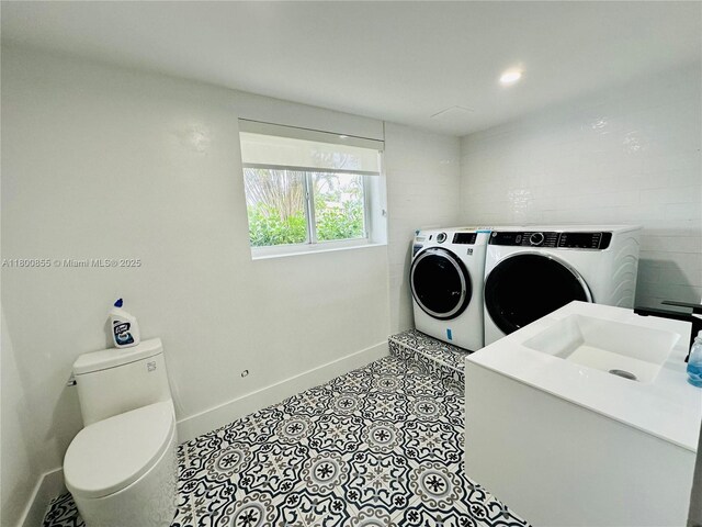 10361 NE 4th Ave, Miami Shores, FL 33138 - washroom featuring washer and dryer and baseboards