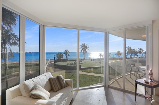 sunroom with a water view and concrete floors
