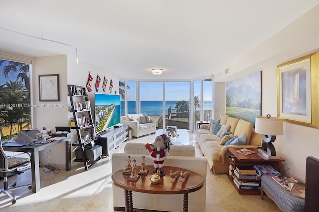 living area featuring light tile patterned floors and floor to ceiling windows