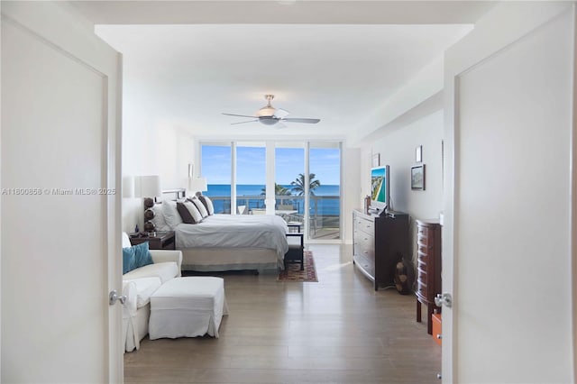bedroom with wood finished floors, access to exterior, and a ceiling fan