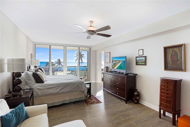 bedroom featuring access to outside, wood finished floors, baseboards, and a ceiling fan