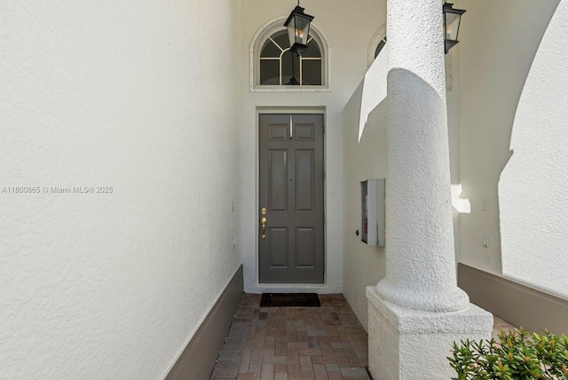 6893 Sterling Grns Unit 201, Naples, FL 34104 - view of exterior entry featuring stucco siding