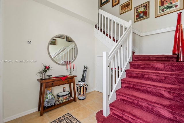 6893 Sterling Grns Unit 201, Naples, FL 34104 - staircase featuring tile patterned floors and baseboards