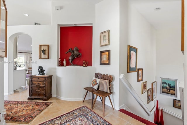 6893 Sterling Grns Unit 201, Naples, FL 34104 - living area with arched walkways, tile patterned floors, and a towering ceiling