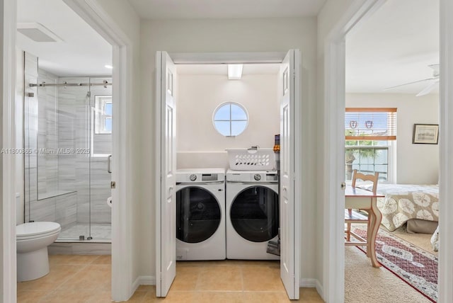 6893 Sterling Grns Unit 201, Naples, FL 34104 - laundry room with washer and clothes dryer, light tile patterned flooring, and baseboards