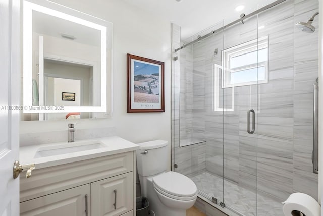 6893 Sterling Grns Unit 201, Naples, FL 34104 - bathroom featuring a stall shower, vanity, and toilet