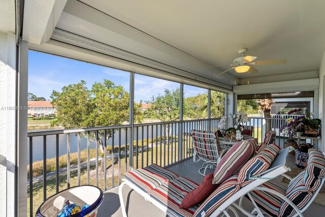 6893 Sterling Grns Unit 201, Naples, FL 34104 - sunroom with a ceiling fan, a water view, and healthy amount of natural light
