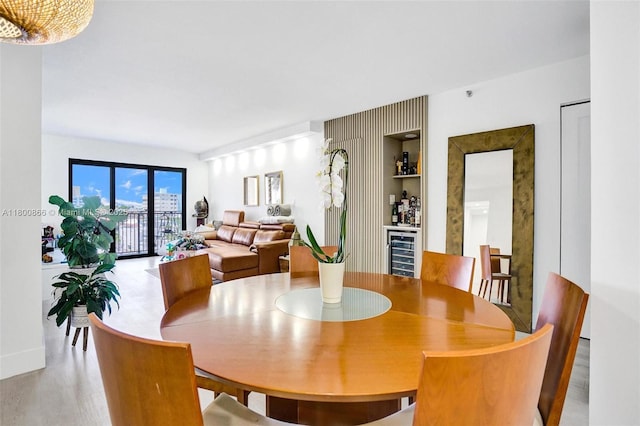 1201 S Ocean Dr Unit 404N, Hollywood, FL 33019 - dining space with beverage cooler, light wood-style floors, and a bar