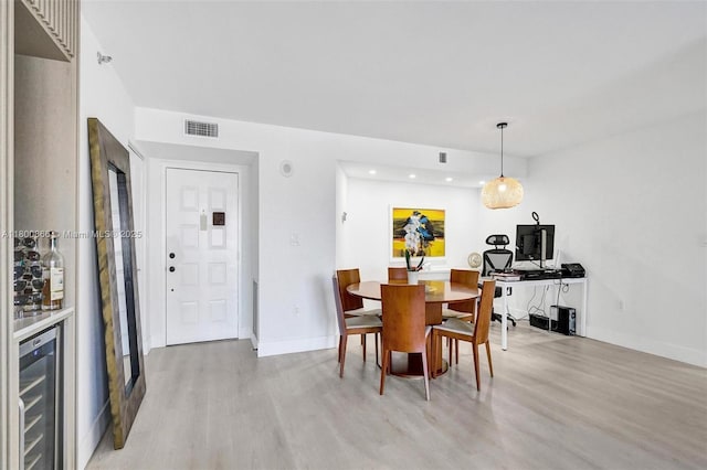 1201 S Ocean Dr Unit 404N, Hollywood, FL 33019 - dining space with beverage cooler, light wood finished floors, recessed lighting, baseboards, and bar