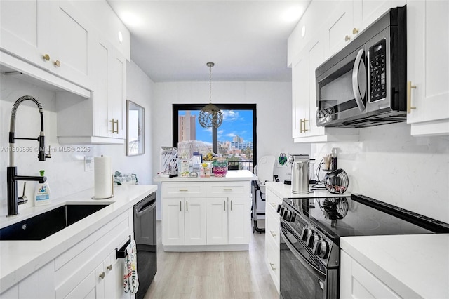 1201 S Ocean Dr Unit 404N, Hollywood, FL 33019 - kitchen with stainless steel microwave, black electric range, a sink, dishwasher, and white cabinetry