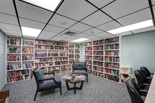 1201 S Ocean Dr Unit 404N, Hollywood, FL 33019 - sitting room featuring bookshelves, carpet floors, built in shelves, and a drop ceiling