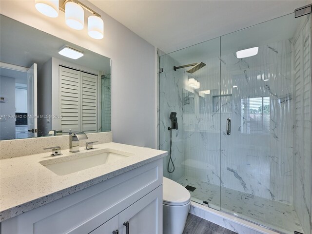 5380 Cedar Lake Dr Unit 204, Boynton Beach, FL 33437 - full bath with a marble finish shower, toilet, vanity, and wood finished floors