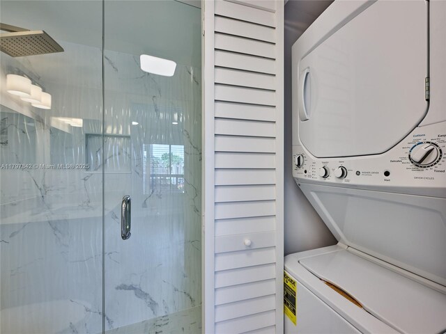 5380 Cedar Lake Dr Unit 204, Boynton Beach, FL 33437 - bathroom with estacked washer and dryer and a marble finish shower