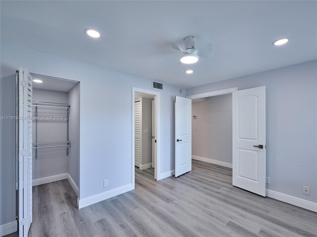 5380 Cedar Lake Dr Unit 204, Boynton Beach, FL 33437 - unfurnished bedroom featuring wood finished floors, baseboards, a walk in closet, a closet, and recessed lighting
