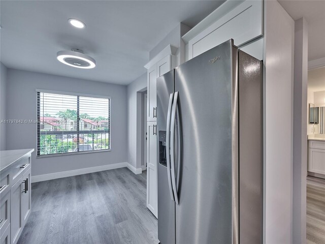 5380 Cedar Lake Dr Unit 204, Boynton Beach, FL 33437 - kitchen with stainless steel fridge, light wood-style floors, light countertops, and baseboards