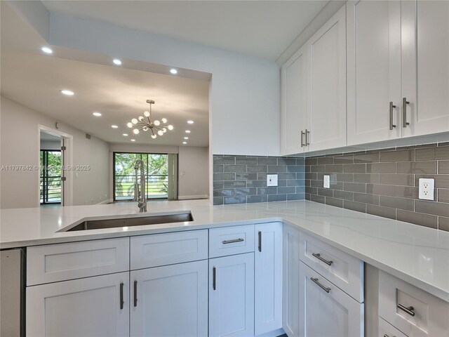 5380 Cedar Lake Dr Unit 204, Boynton Beach, FL 33437 - kitchen with a sink, recessed lighting, decorative backsplash, white cabinetry, and a chandelier