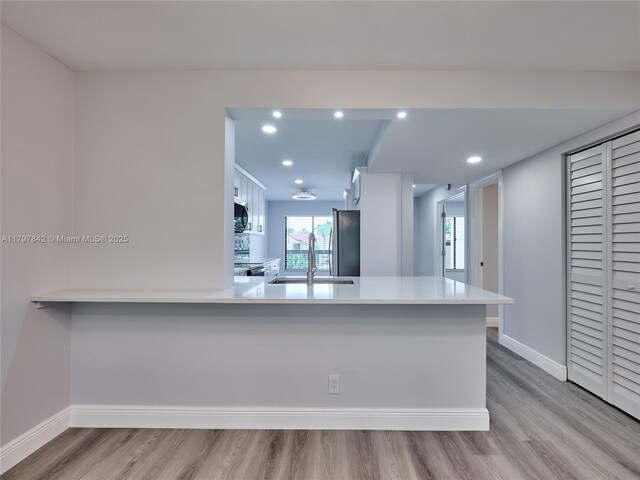 5380 Cedar Lake Dr Unit 204, Boynton Beach, FL 33437 - kitchen featuring a sink, appliances with stainless steel finishes, wood finished floors, light countertops, and recessed lighting