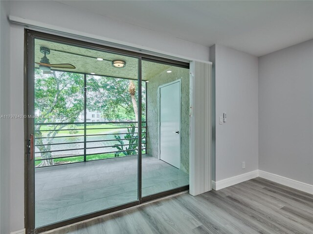 5380 Cedar Lake Dr Unit 204, Boynton Beach, FL 33437 - spare room with wood finished floors, plenty of natural light, and baseboards