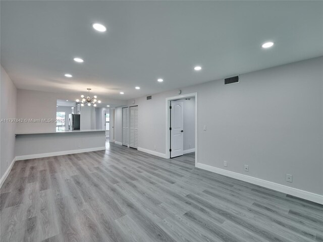 5380 Cedar Lake Dr Unit 204, Boynton Beach, FL 33437 - unfurnished living room with recessed lighting, a chandelier, wood finished floors, and baseboards