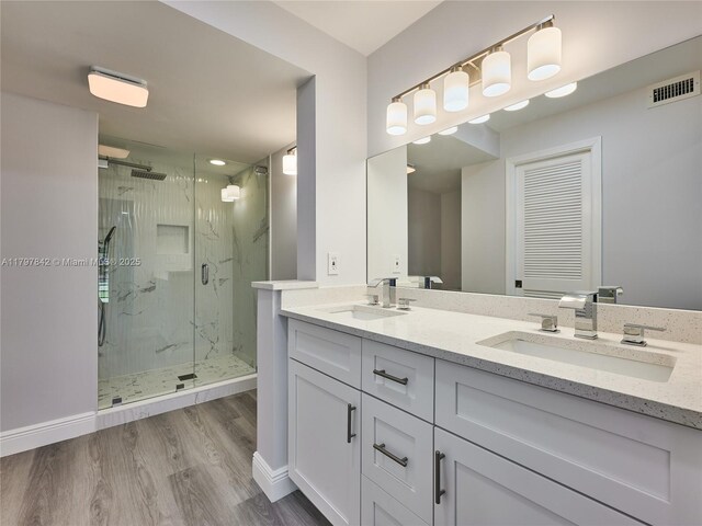 5380 Cedar Lake Dr Unit 204, Boynton Beach, FL 33437 - full bath featuring a marble finish shower, double vanity, wood finished floors, and baseboards