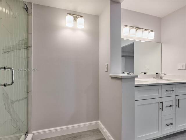 5380 Cedar Lake Dr Unit 204, Boynton Beach, FL 33437 - full bathroom featuring a marble finish shower, wood finished floors, vanity, and baseboards