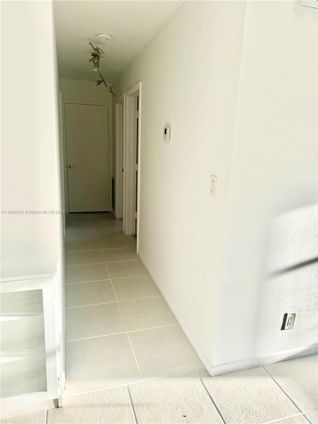 3000 NE 16th Ave Unit 209, Oakland Park, FL 33334 - hallway featuring light tile patterned floors and baseboards