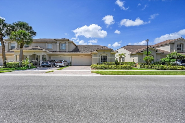 23157 Addison Lakes Cir, Boca Raton, FL 33433 - mediterranean / spanish-style home with driveway, a garage, stucco siding, a tile roof, and a residential view