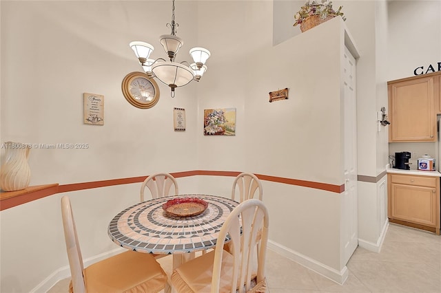 23157 Addison Lakes Cir, Boca Raton, FL 33433 - dining area with a chandelier, light tile patterned floors, baseboards, and a towering ceiling