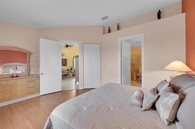23157 Addison Lakes Cir, Boca Raton, FL 33433 - bedroom featuring vaulted ceiling, light wood-style flooring, and a closet