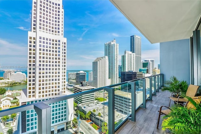 balcony with a view of city and a water view