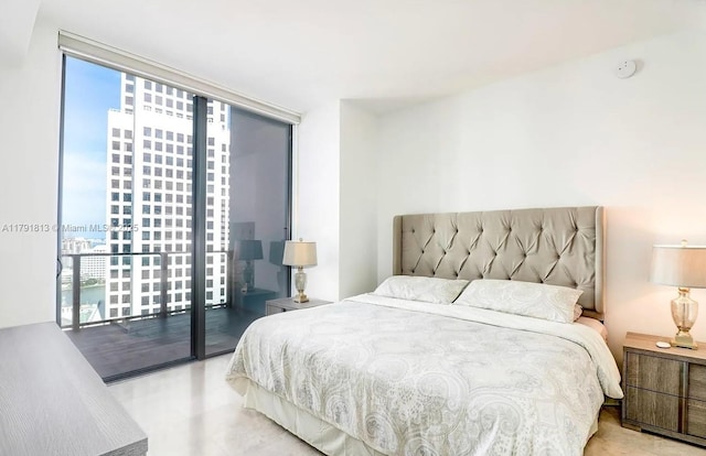 bedroom with access to outside and a city view