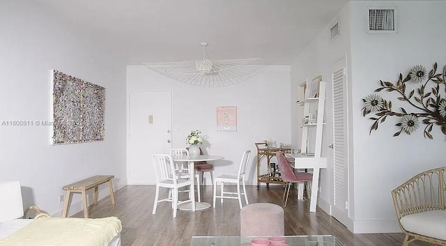 dining space featuring wood finished floors and baseboards