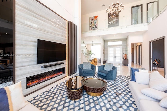 9625 Vescovato Way, Boca Raton, FL 33496 - living room featuring a premium fireplace, french doors, and a towering ceiling