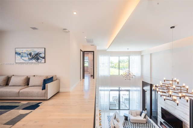 9625 Vescovato Way, Boca Raton, FL 33496 - living room with a chandelier, wood finished floors, and baseboards