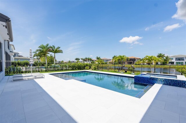9625 Vescovato Way, Boca Raton, FL 33496 - view of pool with a patio area, a fenced backyard, a pool with connected hot tub, and a water view