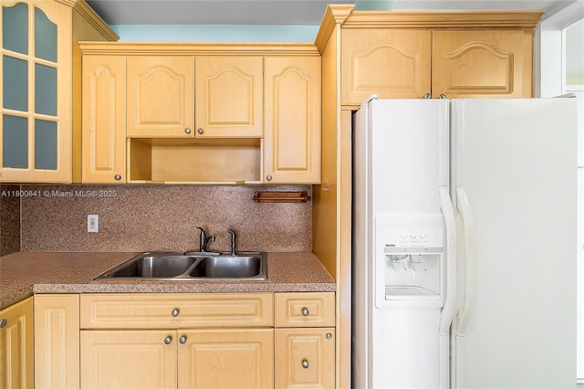 kitchen with white fridge with ice dispenser, a sink, light brown cabinets, and tasteful backsplash