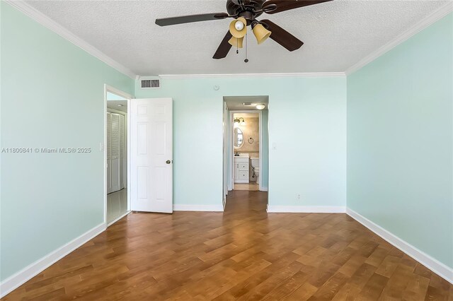 2025 NE 164th St Unit 907, North Miami Beach, FL 33162 - unfurnished bedroom featuring wood finished floors, a textured ceiling, crown molding, baseboards, and a ceiling fan