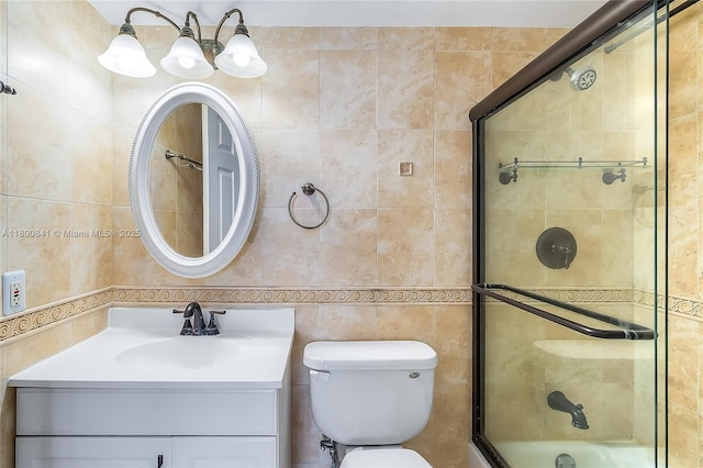 full bathroom featuring tile walls, an enclosed shower, vanity, and toilet
