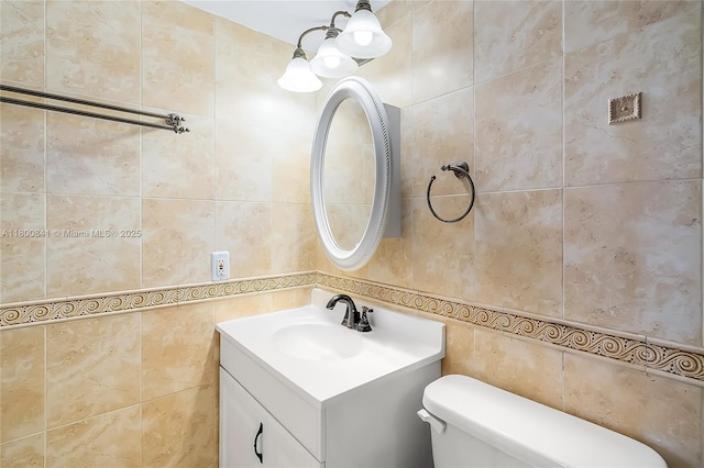 bathroom featuring tile walls, toilet, and vanity