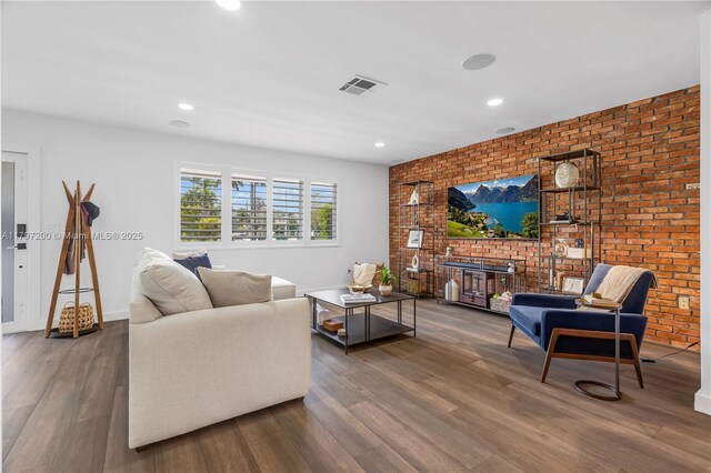 9621 SW 59th Ter, Miami, FL 33173 - living room with wood finished floors, brick wall, recessed lighting, and baseboards