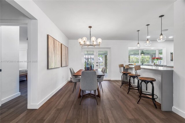 9621 SW 59th Ter, Miami, FL 33173 - dining area featuring dark wood-style floors, baseboards, and a chandelier