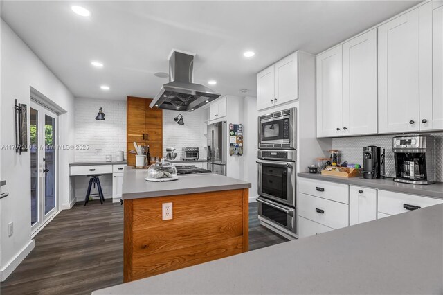 9621 SW 59th Ter, Miami, FL 33173 - kitchen with appliances with stainless steel finishes, island range hood, decorative backsplash, recessed lighting, and a warming drawer