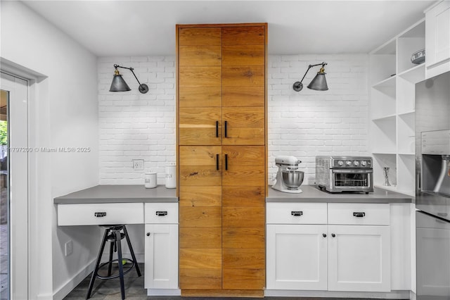9621 SW 59th Ter, Miami, FL 33173 - kitchen featuring white cabinetry, open shelves, tasteful backsplash, and stainless steel refrigerator with ice dispenser