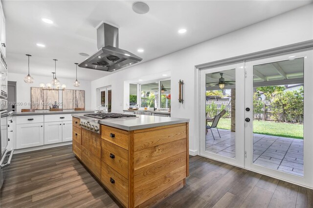 9621 SW 59th Ter, Miami, FL 33173 - kitchen with island exhaust hood, stainless steel gas cooktop, dark wood-type flooring, white cabinetry, and recessed lighting