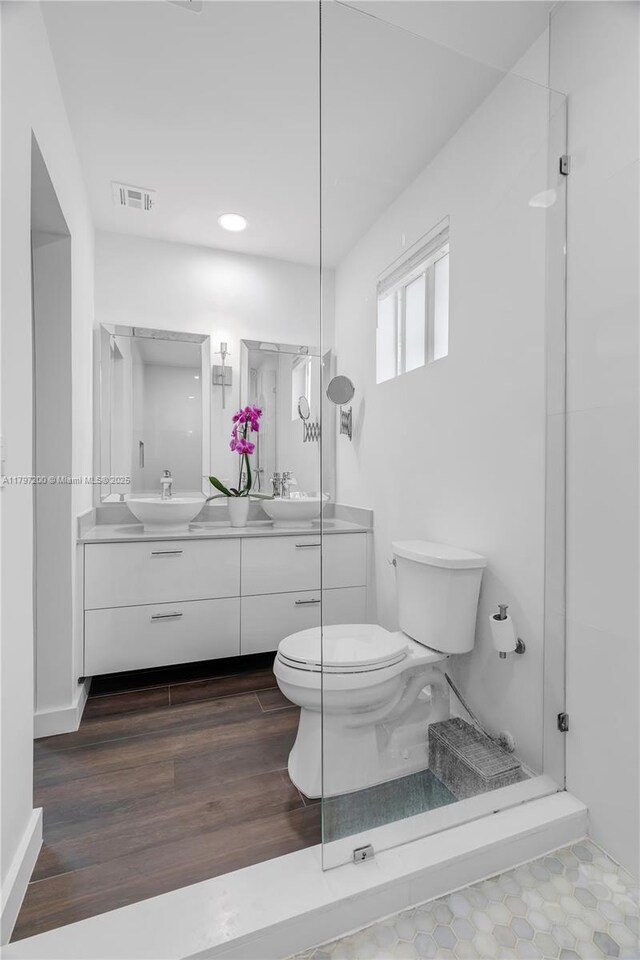 9621 SW 59th Ter, Miami, FL 33173 - bathroom featuring toilet, double vanity, wood finished floors, and baseboards